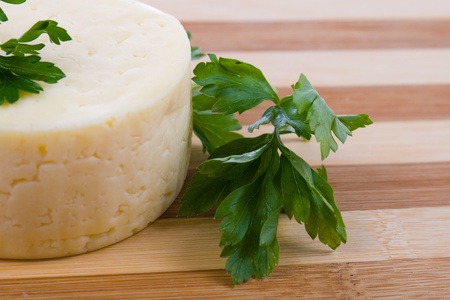 Round cheese on a wooden boardの写真素材