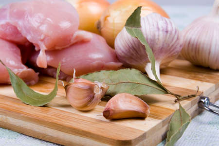 Chicken fillet with vegetables on a wooden boardの写真素材