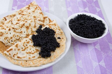 Pancakes with black caviar. The celebration of Maslenitsa - Russian religious and folk holiday.の写真素材