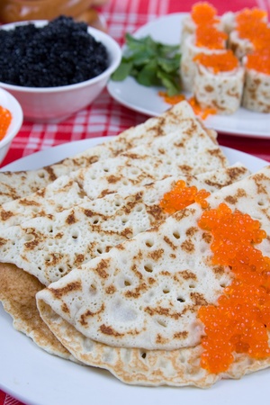 Rolls from pancakes with red and black caviar.The celebration of Maslenitsa - Russian religious and folk holiday.の写真素材