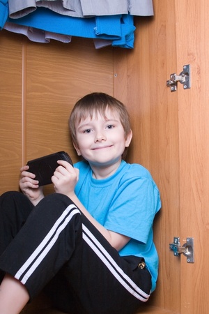 Boy plays a video game sitting in a caseの写真素材