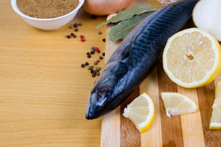 Raw mackerel and spices on a wooden tableの写真素材