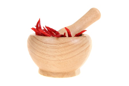 Chili in a wooden pounder, isolated on white backgroundの写真素材