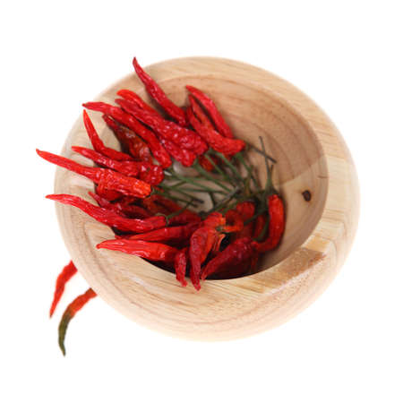 Chili in a wooden pounder, isolated on white backgroundの写真素材