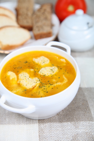 Soup with dumplings in a white plate on the tableの写真素材