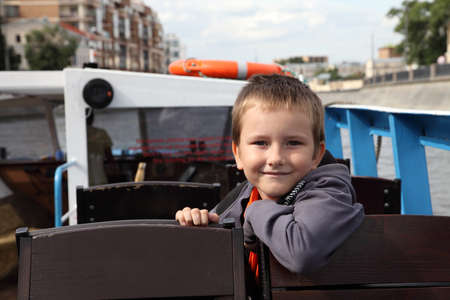 Boy riding excursion boat on the Moscow Riverの写真素材