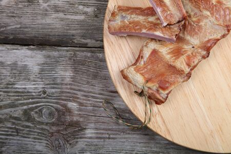 Smoked pork ribs on a wooden boardの写真素材