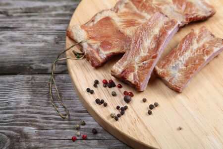 Smoked pork ribs on a wooden boardの写真素材