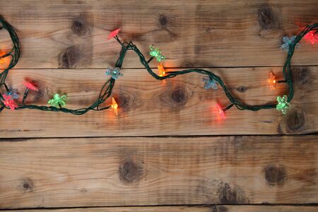 Christmas lights on a wooden background with copy space. Decorative garland の写真素材
