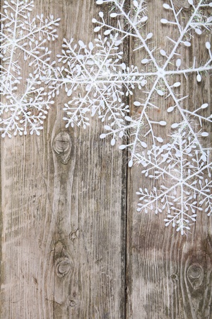 Christmas snowflakes on a wooden background の写真素材