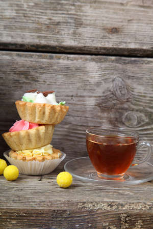 French-press, cup of tea and cakes on old wooden tableの写真素材
