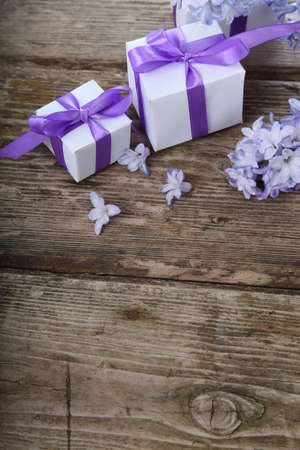 Gift boxes and blue hyacinth on a wooden backgroundの写真素材