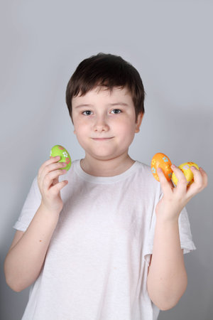 Boy with Easter eggs on a light background
