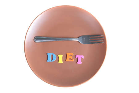 Word diet and fork on a plate isolated on a white background.の写真素材
