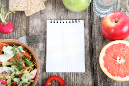 Healthy food for diet and blank note on a wooden tableの写真素材