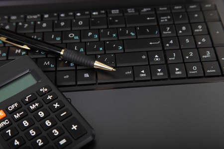 Calculator, laptop,tablet and financial documents on the tableの写真素材