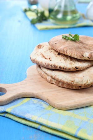 Fresh pitta bread on a wooden table