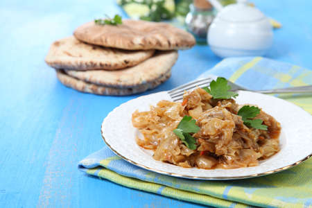 Stewed cabbage on a blue wooden table