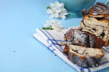 Strudel with poppy seeds on a blue wooden tableの写真素材