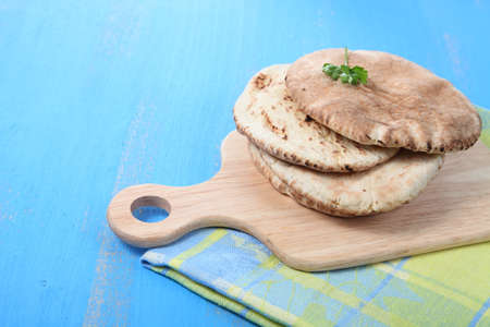 Fresh pitta bread on a wooden tableの写真素材