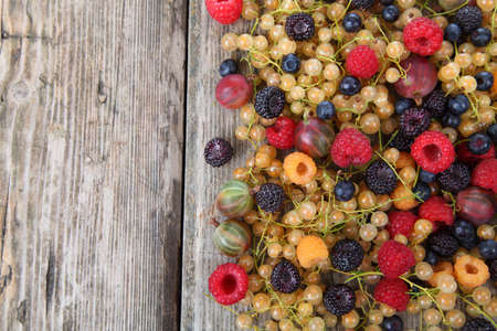 Different ripe berries on a wooden  table