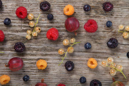 Different ripe berries on a wooden  table