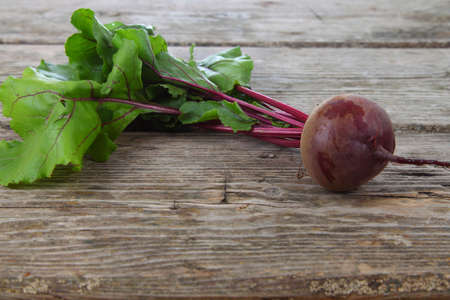 Beetroot with leaves on a wooden background