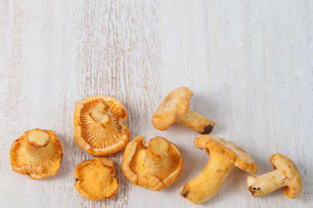 Chanterelles in a basket on a wooden tableの写真素材