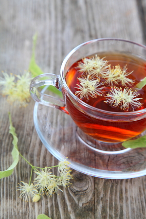 Herbal tea with linden on an old wooden tableの写真素材
