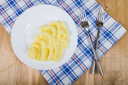 Mashed potatoes in a white plate on the tableの写真素材
