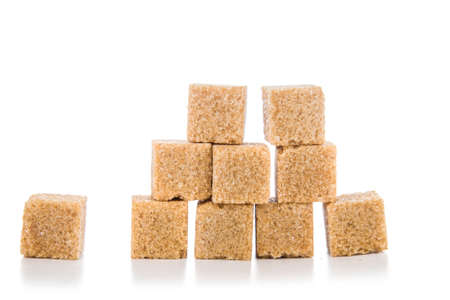Pieces of cane sugar isolated on a white backgroundの写真素材