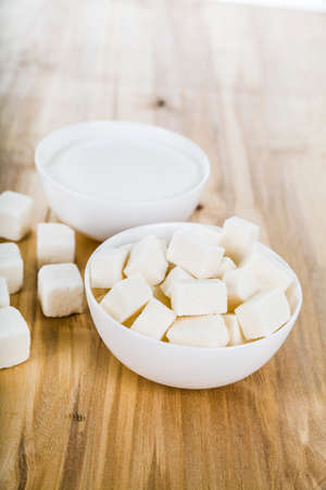 Sugar in a white bowl on the tableの写真素材