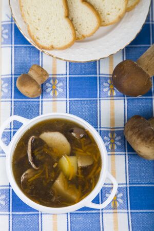 Soup of wild mushrooms on a wooden tableの写真素材