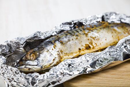 Baked mackerel on the foil closeup. Preparation of fresh fish.の写真素材