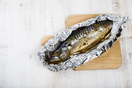 Baked mackerel on the foil closeup. Preparation of fresh fish.の写真素材