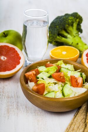 Food for diet  on a wooden table. Concept of diet and healthy lifestyle.の写真素材