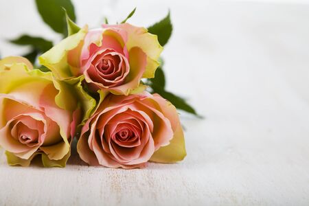 Pink roses on a wooden background. Greeting card with Valentine's Day, Birthday or Wedding.の写真素材