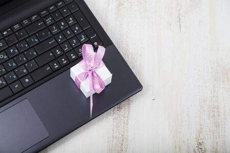 Gift box on a laptop. Buying gifts for the holidays online.の写真素材