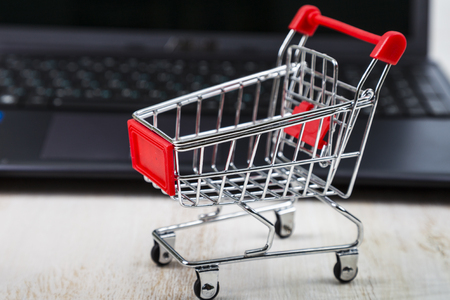 Shopping basket on a laptop. Concept of shopping online.の写真素材