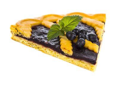 Piece of berry pie with mint isolated on white background. Delicious baking with berries.の写真素材