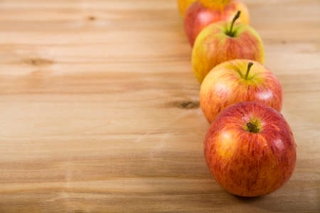 Red apples on a wooden table. Concept of diet and healthy lifestyle.の写真素材