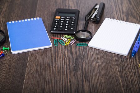 Businessman's table. Notepad, pen, calculator and compass on the table. Navigation in the world of...