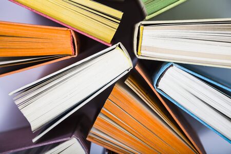 Multicolored books, top view. A lot of books are close-up.の写真素材