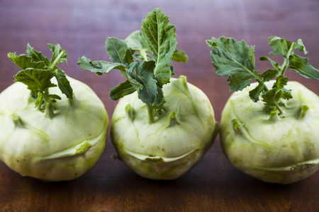 Kohlrabi on a wooden table. Delicious cabbage close-up, healthy eating.の写真素材