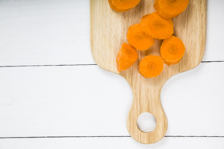 Sliced carrots on a cutting board on a wooden table. Tasty and healthy food. Diet.の写真素材