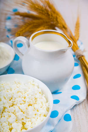 Cottage cheese, sour cream and milk on a wooden table. Healthy dairy products.の写真素材