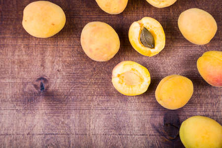 Apricots on a wooden table. Delicious and healthy dessert close-up, healthy diet.