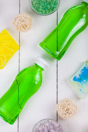 Spa treatments on a white wooden table.Shower gel, sea salt and soap, top viewの写真素材