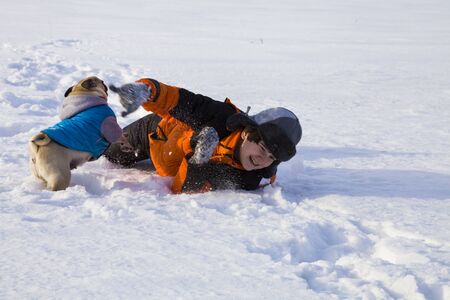 Boy and dog walking in winterの写真素材