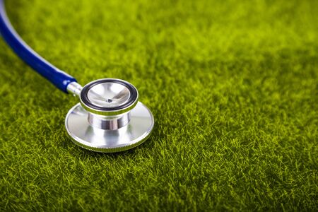 Stethoscope on green grass close-up. Nature and medicine.の写真素材